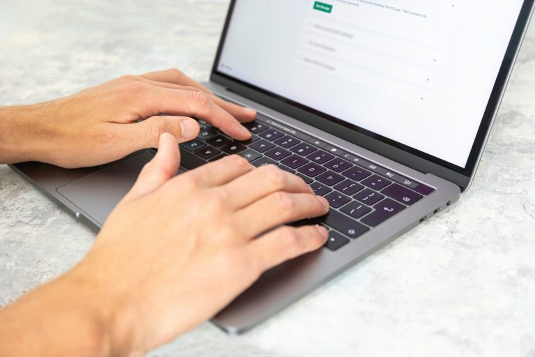 Copywriter Typing On Laptop